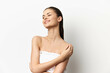 © SHOTPRIME STUDIO - Beautiful young woman with smooth skin, smiling, standing against a plain white background, showcasing natural beauty and confidence, ideal for skincare or beauty concepts