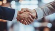 © InfiniteStudio - Business collaboration evident in close-up handshake between manager and worker in warehouse environment