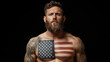© pattozher - Patriotic Pride: A muscular man with a US flag painted on his chest, embodying strength and national identity, against a dark background, evokes a sense of patriotism and dedication.