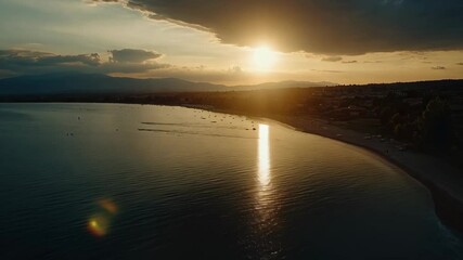 Wall Mural - sunset over the tranquil coast with shimmering reflections on the water and distant hills in the bac