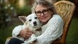 © Chaikit - heartfelt pet companionship, mature woman with modern glasses, cuddling white hunting dog, garden chair setting, country home environment, green lawn backdrop, documentary style photography, warm