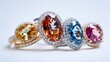 A collection of three colorful gemstone rings, each featuring a different stone, displayed on a white background
