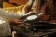 © pressmaster - Closeup of hands placing vinyl record on turntable in cozy, vintage-inspired room with warm lighting, capturing a nostalgic atmosphere evocative of past eras