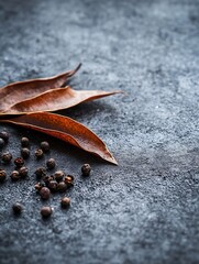 Poster - Stylish arrangement of dried leaves and black peppercorns on a dark textured surface : Generative AI