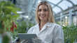 © Ari - French agricultural scientist woman holding tablet working in chile plant modern greenhouse