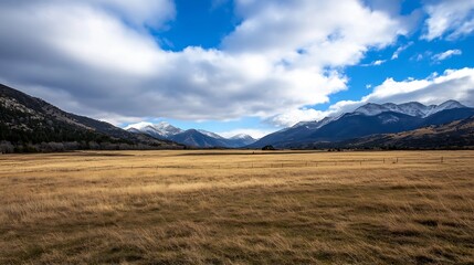 Poster - Breathtaking panoramic view of vast grassy valley with majestic mountains under blue sky : Generative AI