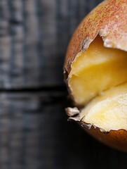 Poster - Closeup view of a broken ripe pear revealing its juicy interior alongside rustic wood : Generative AI