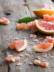 Poster - Fresh grapefruit pieces sprinkled with coarse salt on a rustic wooden table : Generative AI
