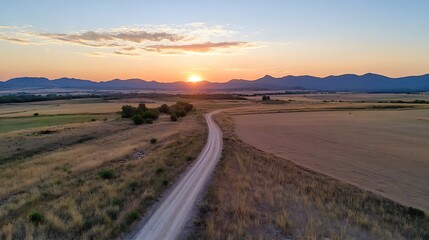 Aufkleber - Stunning aerial view of a scenic countryside road winding through golden fields at sunset : Generative AI