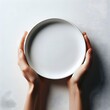 © Srejon - hand holding empty blue plate on white  background with copy space. Healthy eating, dieting concept. Banner