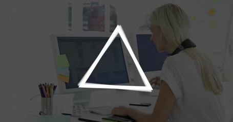 Poster - Woman working at desk with glowing triangle animation over computer screen
