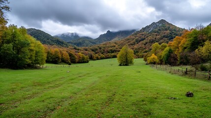 Canvas Print - Vibrant Autumn Landscape of a Green Meadow Surrounded by Colorful Mountains and Cloudy Sky : Generative AI