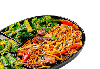 Wall Mural - Delicious stir-fried noodles served with vegetables on a platter