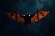 © Kachaphot - Dark brown flying bat silhouette with rough textured wings against a dark blue background, night sky, wildlife, flying bat