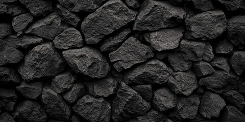Poster - A close-up of various dark, textured rocks arranged haphazardly, showcasing their natural form and surface details.