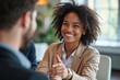 ©  S u n n y B u n n y - Portrait of a 30-Year-Old Black Woman in a Business Setting, Engaging in a Professional Handshake with a Colleague During a Meeting