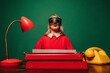 © VISTA by Westend61 - Stylish woman in red dress with VR glasses at a typewriter in a creative office setting
