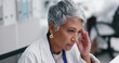 © peopleimages.com - Woman, senior doctor and headache in lab, pain and stress with medical research crisis and burnout. Migraine, hurt and scientist with brain fog, fatigue and temple massage for tension in workplace