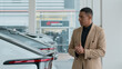 © Yuliia - Thoughtful African American man ethnic male guy business client buyer pensive doubtful customer thinking dreaming about buying luxurious expensive automobile choosing new car in auto salon dealership