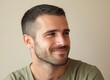 © MUdaylah - Portrait of a handsome, smiling man looking away, with a light beige background and blurred face. This is the winning stock photo for a text contest,