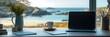© Stock4u2024  - Coastal Workspace: A laptop sits open on a desk overlooking a stunning coastal vista, capturing a blend of work and tranquility.