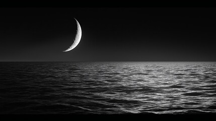 Poster - A crescent moon rising over a pure black ocean