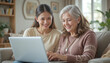 © aiartth - A young adult Hispanic daughter helps her senior mother navigate an online banking application on a laptop, sharing a warm and educational moment at home.