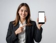 © Aodsy - Young woman in business attire showcasing smartphone with blank screen