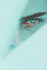 Fototapete - Minimalist composition featuring only a partial view of the face, focusing on luminous blue eyes