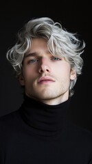 Poster - A man with a gray head of hair is wearing a black shirt and a black sweater
