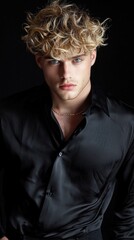 Poster - A man with curly blonde hair is wearing a black shirt and a necklace
