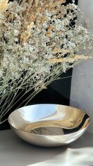 Poster - Elegant silver bowl surrounded by dried flowers modern interior still life bright atmosphere