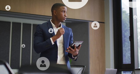Poster - Image of network of people icons over african american businessman in office