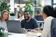 © Rafa Fernandez - Diverse team collaborating and smiling in a modern office.