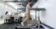 © peopleimages.com - Man, walking and treadmill with a businessman in the breakroom of his office for exercise or mobility. Fitness, health or corporate with a male employee in staying active in the workplace