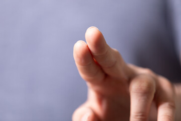 Poster - High-quality image of a hand with two fingers extended, ideal for presentations or web design.
