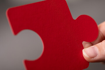 Poster - Close-up of a single red puzzle piece.  Perfect for teamwork, solutions, and connection concepts.