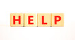 © Dzmitry - Help symbol. Concept word Help on beautiful wooden blocks. Beautiful white table white background. Business, lifestyle, support and help concept. Copy space.