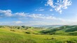 © KOSHKAROV SERGEI - Beautiful panoramic view of lush green hills under a wide blue sky.