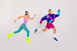 © deagreez - Energetic young couple in vibrant retro activewear joyfully leaping with excitement on a white background.