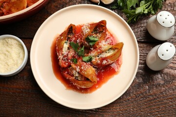 Sticker - Delicious conchiglie pasta with ricotta cheese, tomato sauce and parsley on wooden table, flat lay