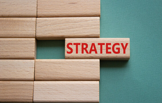 Strategy symbol. Concept word Strategy on wooden blocks. Beautiful grey green background. Business and Strategy concept. Copy space.