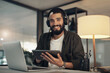 © peopleimages.com - Headphones, portrait and tablet with business man in office for sound engineer, production and night. Audio editor, planning and track release with person in creative agency for podcast recording