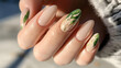 © Alona - Close-up of beautifully manicured nails featuring floral and leaf designs.