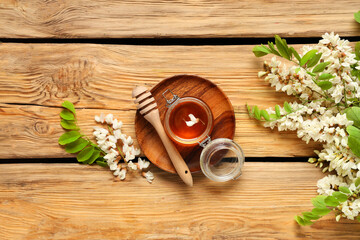 Wall Mural - Jar of sweet honey with acacia flowers and dipper on wooden background