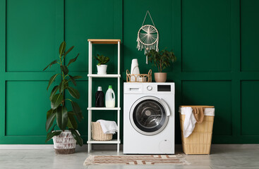 Wall Mural - Modern washing machine, shelving unit and laundry basket near green wall in room