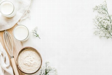 Fototapete - Neutral tones and natural elements in a kitchen setting with dairy products and whisk on a wooden surface. Generative AI