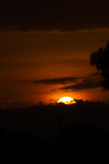 Wall Mural - sunset behind the clouds in the sky, beautiful and dramatic.
