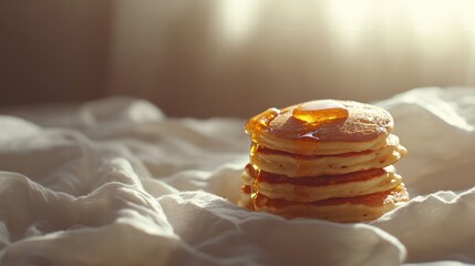 Poster - Stack of fluffy pancakes topped with syrup on a cozy bed sheet in soft morning light. Generative AI