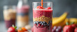 © SlavaOkey - Colorful smoothie layered with fruits and seeds in clear glass